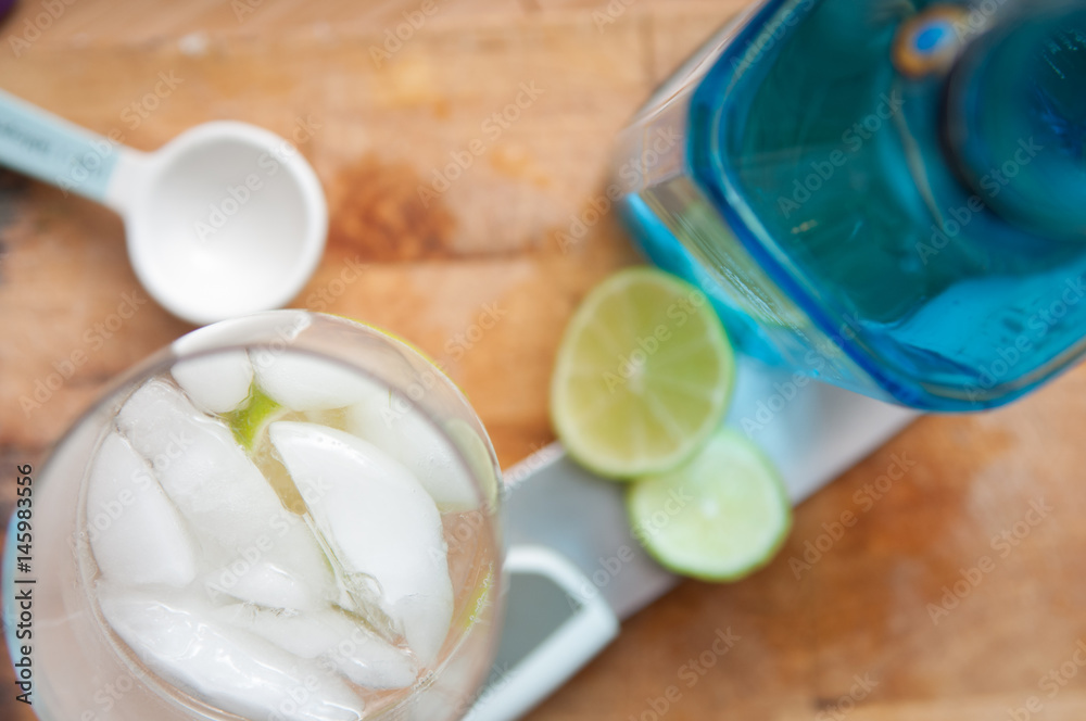 Alcoholic drinks with gin and tonic on a wood table background Alcoholic drinks with gin and tonic on a wood table background