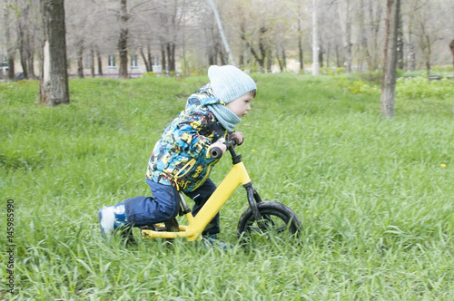 A little boy is riding in a park on a bicycle, a children's sport and an active lifestyle,run bike, balance bike