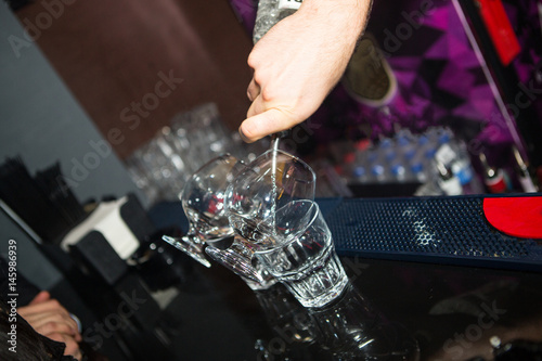 Alcohol cocktail on the bar. Bartender prepares an alcoholic cocktail