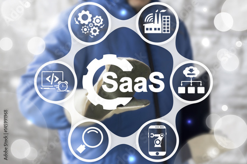 SAAS Computing IOT Industry 4.0 Development Concept. Industrial worker touched gear SaaS icon on virtual screen. Software as a service in manufacturing. photo