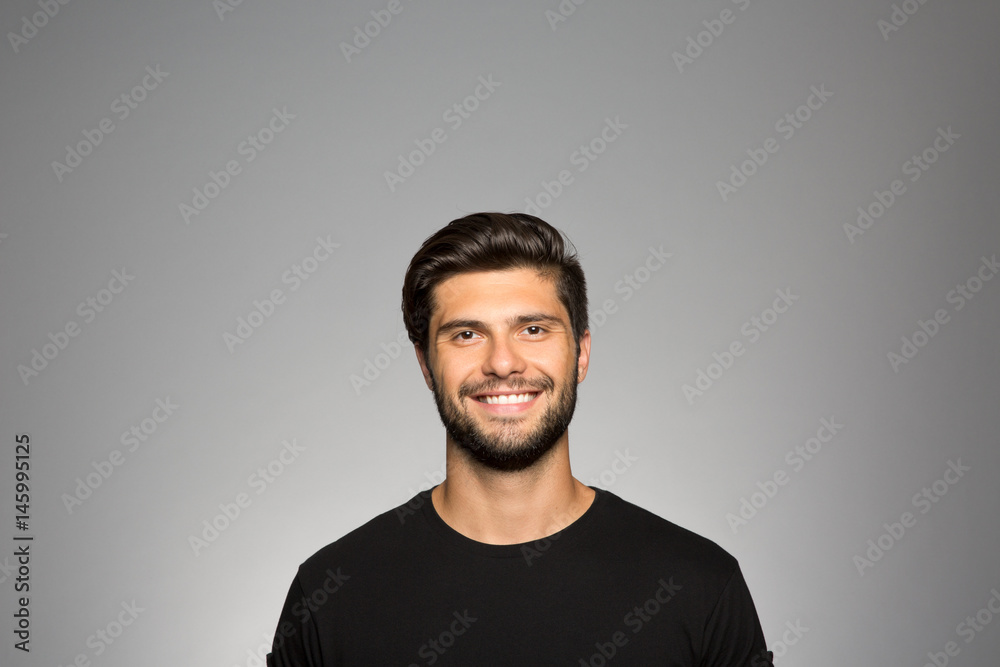 Studio portrait of a young man grinning