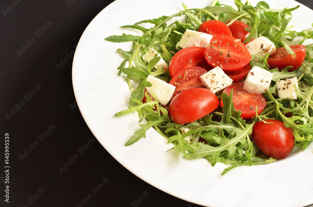 salad with tomatoes, fresh arugula and mozzarella