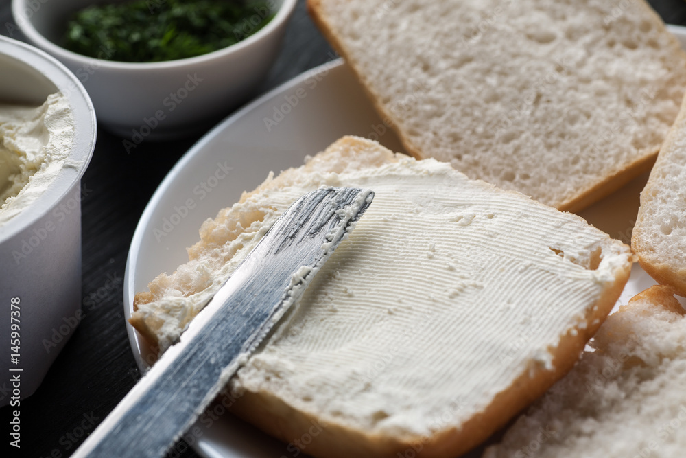 piece of white bread covered with curd cheese