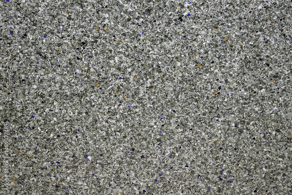Background of concrete dark gray wall and multi-colored gravel with texture. Horizontal frame Background of concrete dark gray wall and multi-colored gravel with texture. Horizontal frame