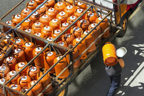 gas bottles with butane in truck with  worker for delivery , lpg  glp photo