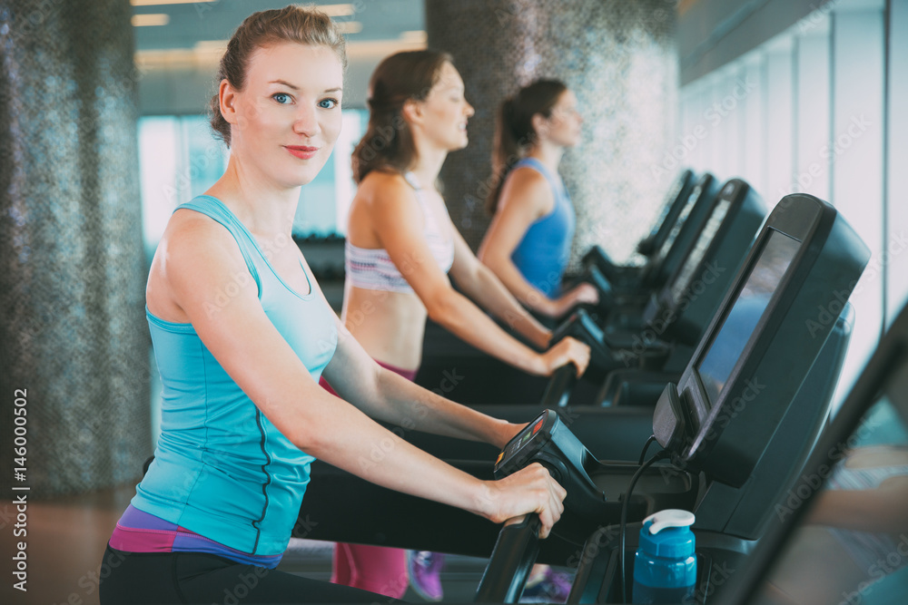 Woman Exercising on Treadmill in Fitness Center Woman Exercising on Treadmill in Fitness Center