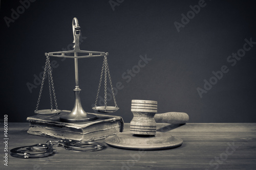 Law scales, judge gavel, old book, handcuff. Symbol of justice.