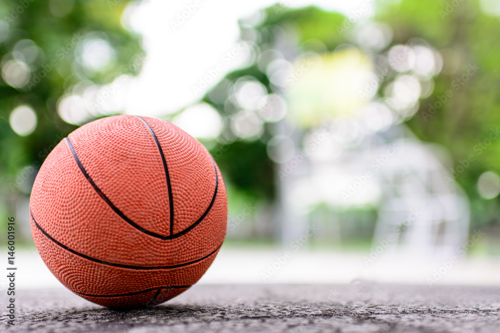orange ball for play basketball on a floor in basketball court at the park orange ball for play basketball on a floor in basketball court at the park