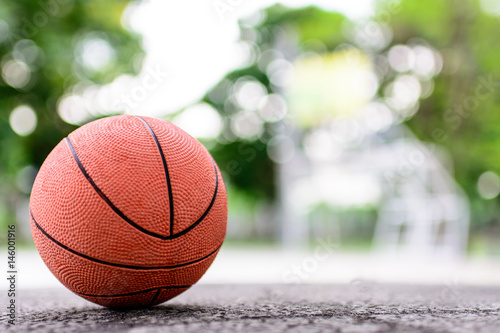 orange ball for play basketball on a floor in basketball court at the park