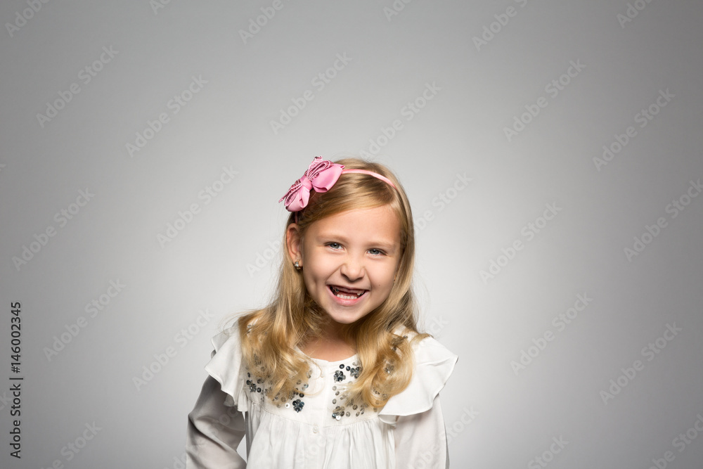 Studio portrait of a girl grinning