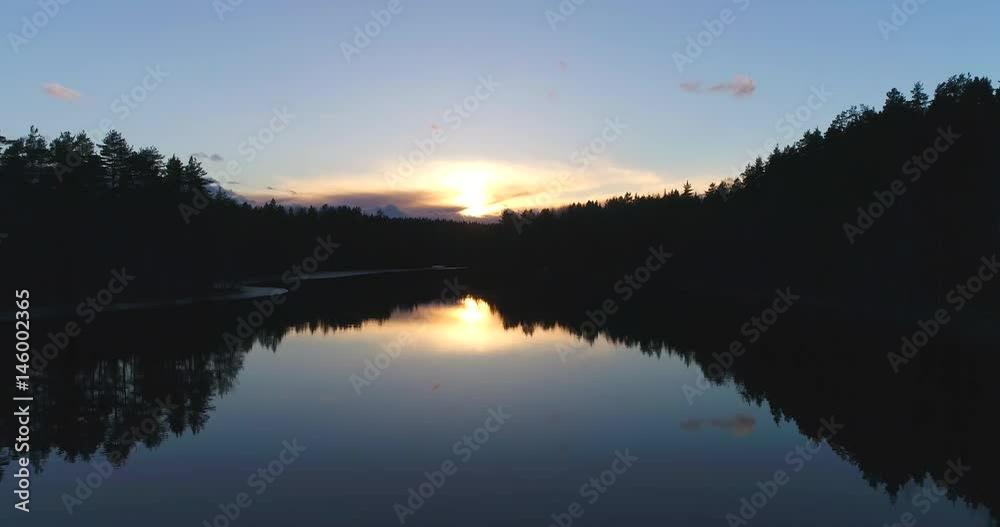 Haukkalampi, Cinema 4k aerial flying above a mirroring haukkalampi pond, at a sunset, and then rising and revealing the nuuksio national park, on a sunny spring evening, in Espoo, Finland Haukkalampi, Cinema 4k aerial flying above a mirroring haukkalampi pond, at a sunset, and then rising and revealing the nuuksio national park, on a sunny spring evening, in Espoo, Finland