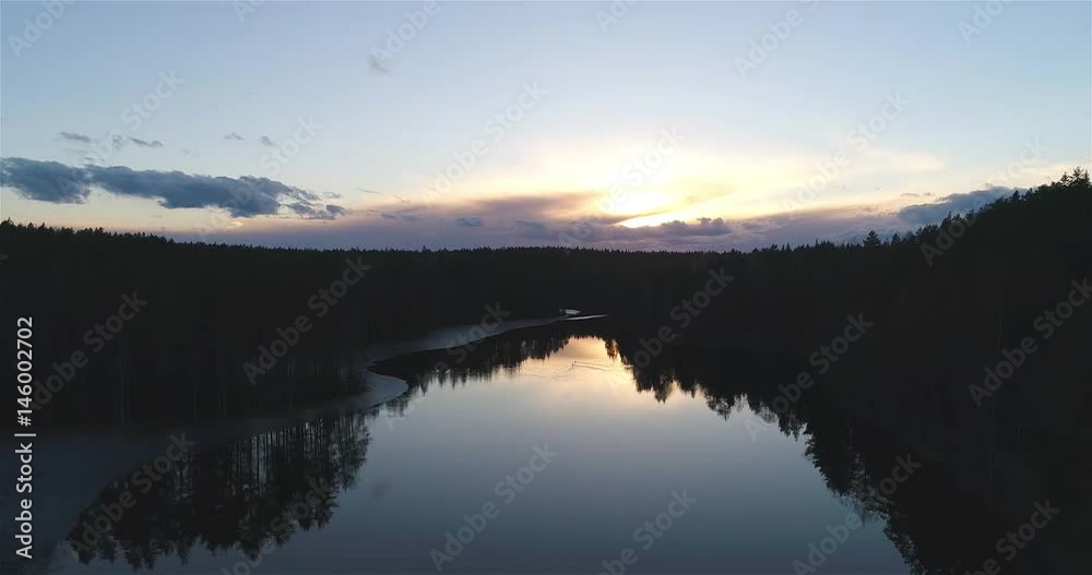 Haukkalampi, Cinema 4k aerial landing view of a mirroring haukkaampi pond, at a sunset, in nuuksio national park, on a sunny spring evening, in Espoo, Finland Haukkalampi, Cinema 4k aerial landing view of a mirroring haukkaampi pond, at a sunset, in nuuksio national park, on a sunny spring evening, in Espoo, Finland