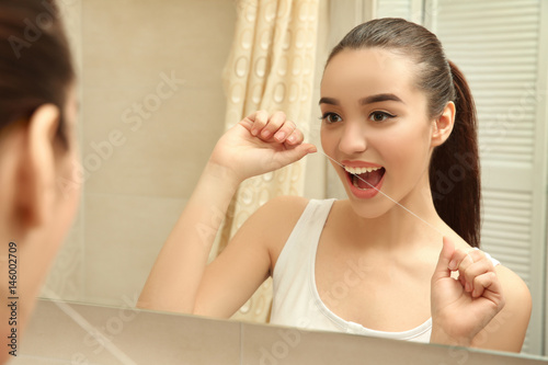 Beautiful woman brushing te...
