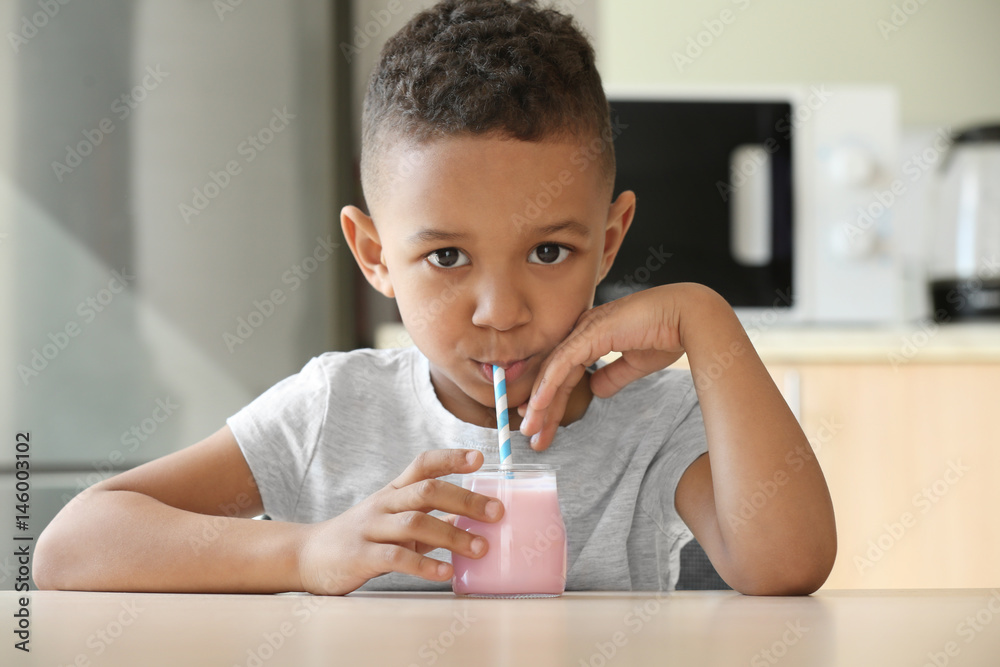 Cute African American boy drinking yogurt at home Stock Photo Adobe Stock