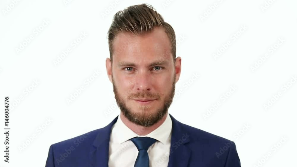 Attractive cool businessman in a blue suit, blue tie and white shirt, standing in front of a white background. Attractive cool businessman in a blue suit, blue tie and white shirt, standing in front of a white background.