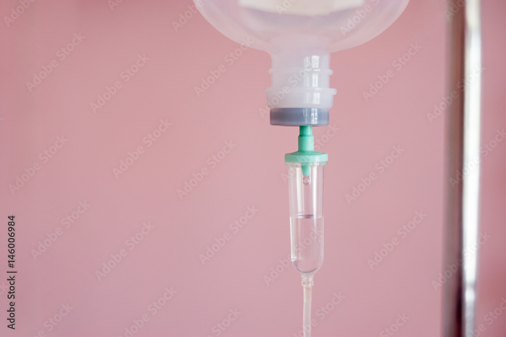 Close up 0.9 % Normal saline solution or sodium chloride drip for patient and infusion pump at Emergency ,operating room in hospital by doctor,Medical corridor concept,with copy space ,vintage color Close up 0.9 % Normal saline solution or sodium chloride drip for patient and infusion pump at Emergency ,operating room in hospital by doctor,Medical corridor concept,with copy space ,vintage color