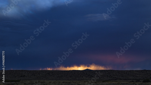 Lightning striking in the distance during a summer storm in the desert 