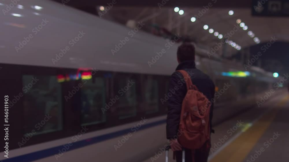 Caucasian male traveler with a backpack preparing to enter fast bullet train. Outdoor adventure travel by train concept. 4K UHD 60 FPS SLO MO Caucasian male traveler with a backpack preparing to enter fast bullet train. Outdoor adventure travel by train concept. 4K UHD 60 FPS SLO MO