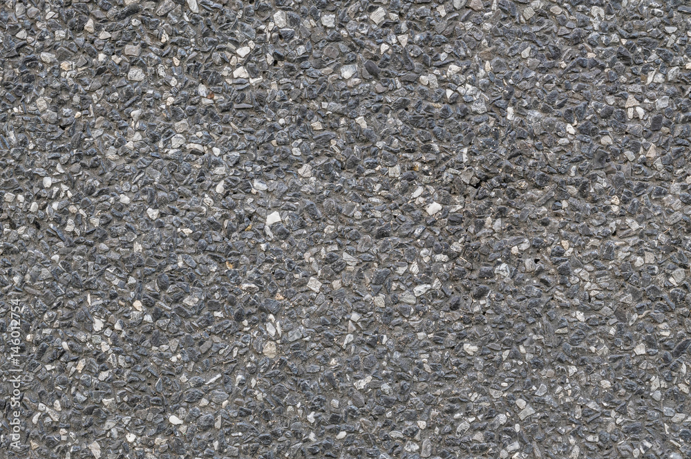 Closeup surface abstract stone pattern at the black stone wall textured background