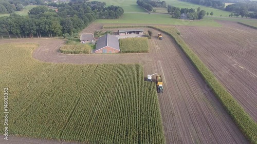Aerial shot of Agriculture machine corn chopping, D-log photo
