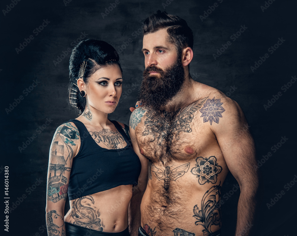 Φωτογραφία Portrait of shirtless, tattooed bearded male and brunette female with tattoo ink on her torso