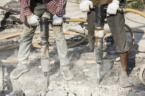 workers working with air concrete hammer drill