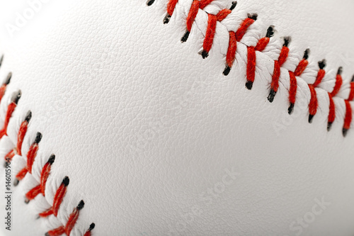 Macro image of a baseball with the closeup on the stitches with copy space