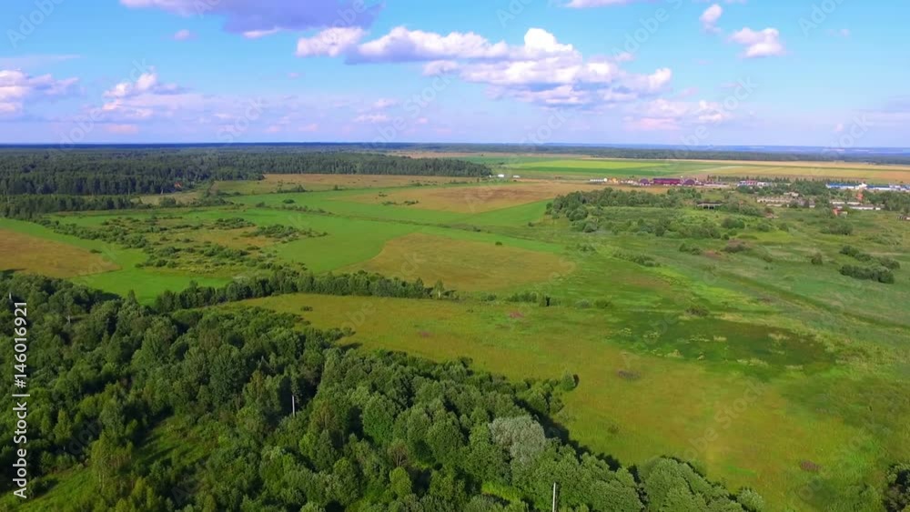 Aerial view of fields, forests and a village on background Aerial view of fields, forests and a village on background