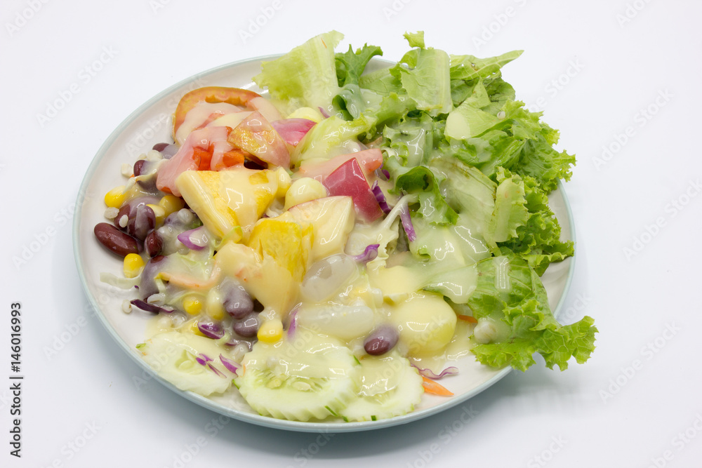 Closeup mixed of fresh salad and fruit on dish. Corn, red beans, pineapple and papaya on white background. Closeup mixed of fresh salad and fruit on dish. Corn, red beans, pineapple and papaya on white background.
