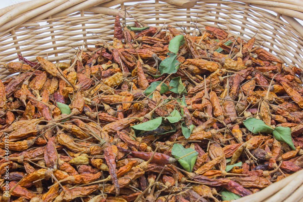 Dried red pepper in basket.