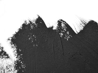 black brush strokes oil paints on white paper macro. Isolated on white background. Creative background