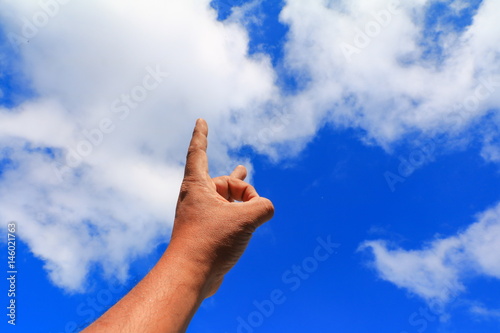 hand pointing or touching to something on blue sky background