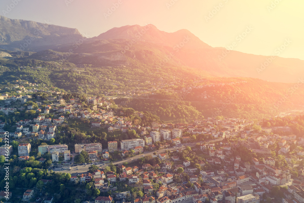 Beautiful city with red roofs in the mountains on a sunny day