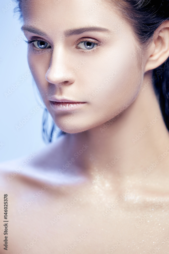 Beautiful woman face portrait close up on blue Beautiful woman face portrait close up on blue