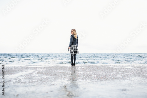 The charming girl stands near sea