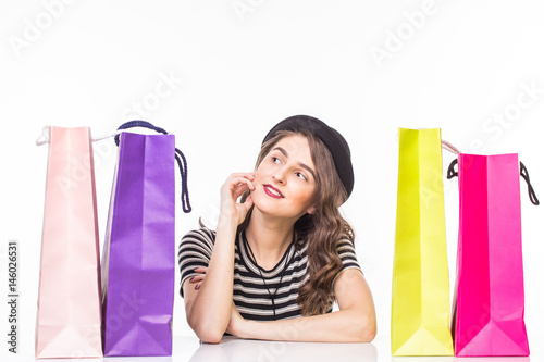 Young beautiful woman with shopping bags on table satisfied and have rest with happy smile on white background photo