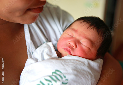 newborn infant Aged 2 Days sleep on mother's chest.