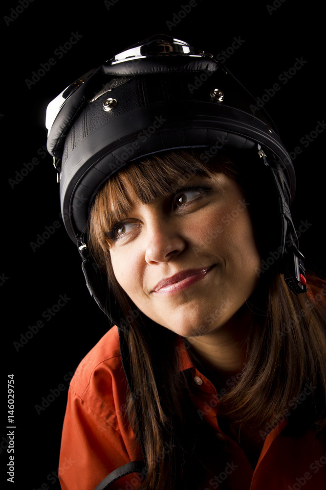 Portrait of emotional young woman with helmet and goggles isolated on black background. Close up. Portrait of emotional young woman with helmet and goggles isolated on black background. Close up.