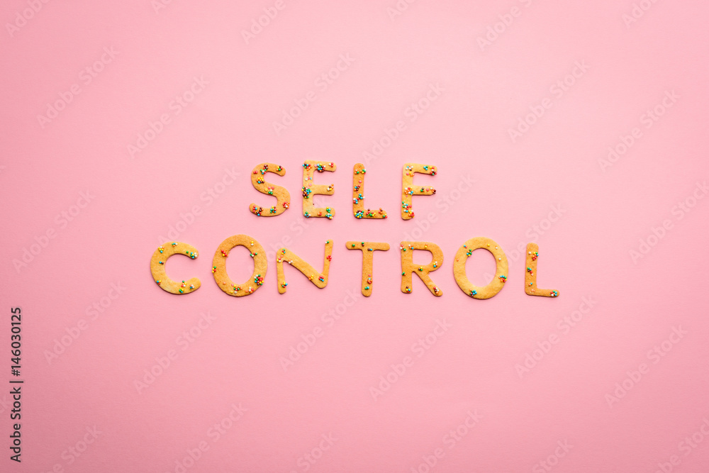 Top view of self control lettering made from sweets isolated on pink, healthy living concept