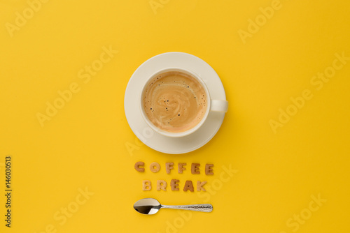 top view of cup of espresso coffee, spoon and coffee break lettering photo