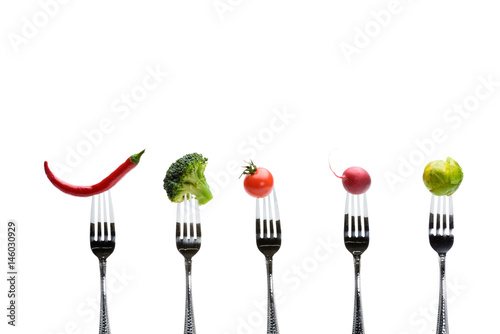 fresh vegetables on forks isolated on white, healthy living concept