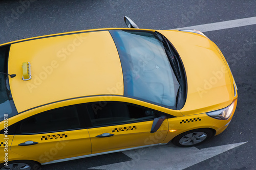 yellow taxi moves on the city
