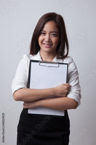 Young Asian business woman hold clipboard.