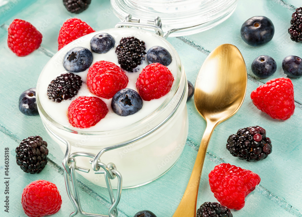 Jar of yogurt with blueberries, blackberries and raspberries. Jar of yogurt with blueberries, blackberries and raspberries.