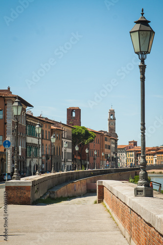 Panorama of the street of the old European city. The prospect of an embankment with lanterns, old houses and a river.