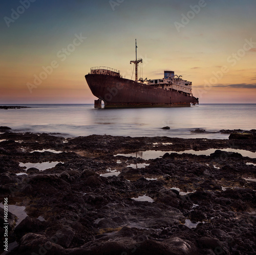 Shipwreck at the sunset on a Lanzarote coast with copy space © rangizzz
