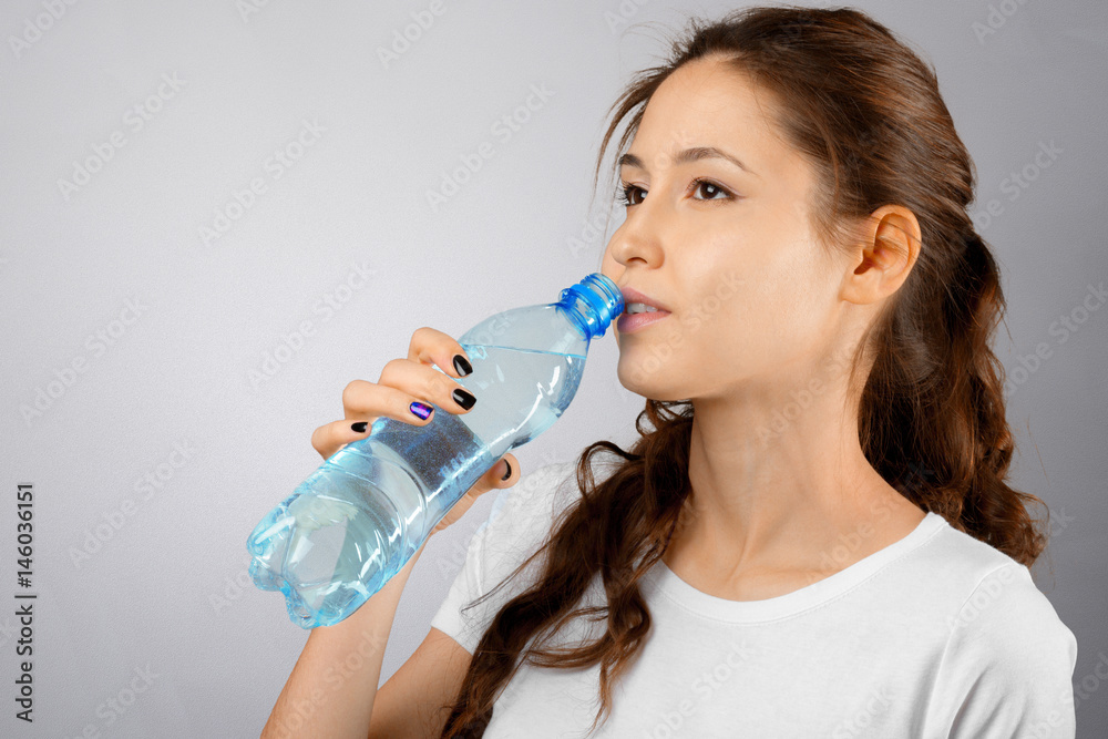 Beautiful young fitness woman with perfect body shape drinking fresh water Beautiful young fitness woman with perfect body shape drinking fresh water