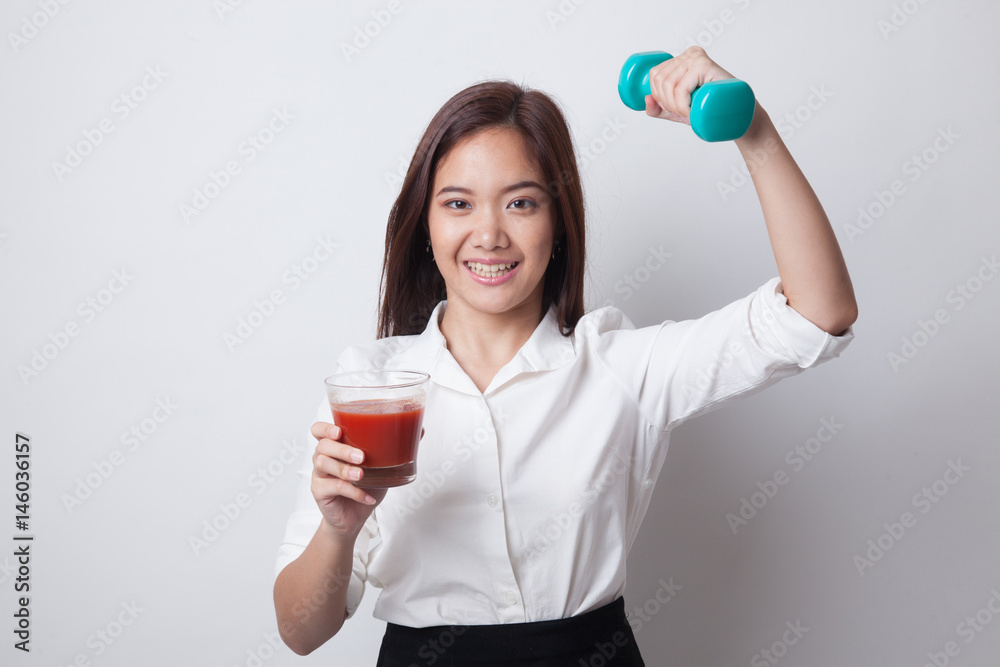 Healthy Asian woman with dumbbell and  tomato juice.