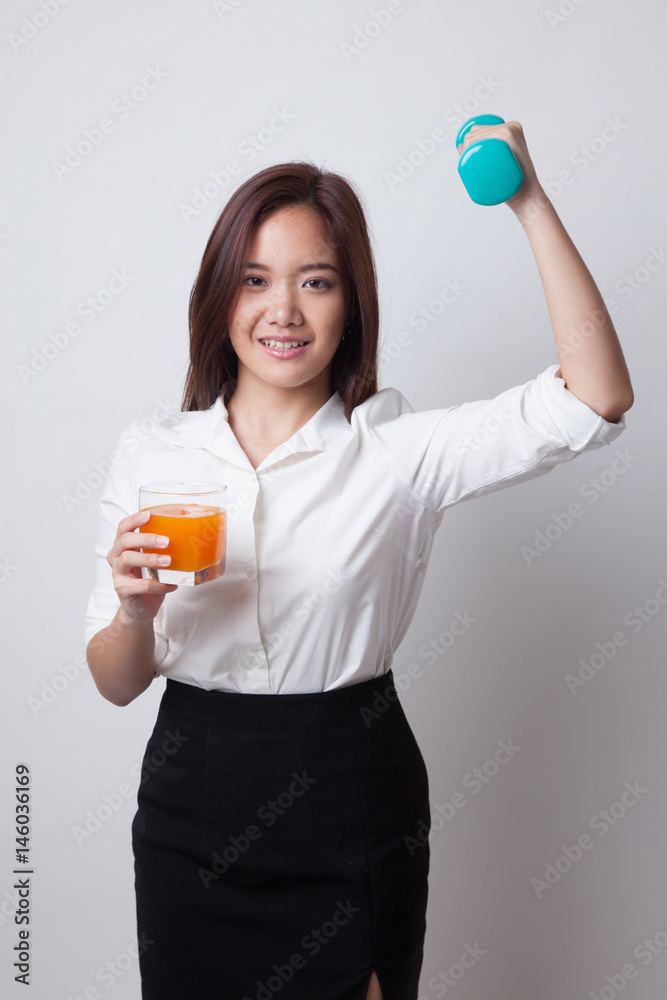 Young Asian woman with dumbbell drink orange juice. Young Asian woman with dumbbell drink orange juice.
