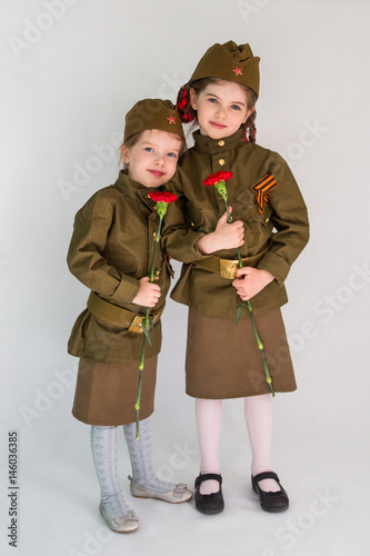 Little girls in military uniform at the May 9 celebration in Russia, Victory Day. Isolated on white background photo